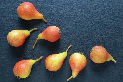 Ripe pears on dark background. Flat lay, copy space Stock Photos