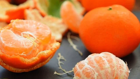 Ripe peeled tangerines on a table Stock Footage 70454493