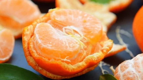 Ripe peeled tangerines on a table Stock Footage 70454940
