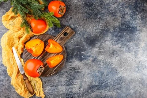 Ripe persimmon fruit on dark Stock Photos