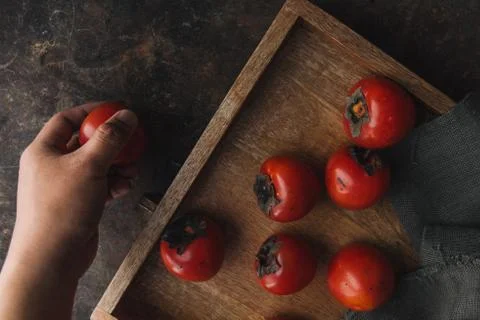 Ripe persimmon on rustic background Stock Photos