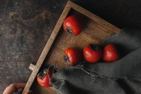 Ripe persimmon on rustic background Stock Photos