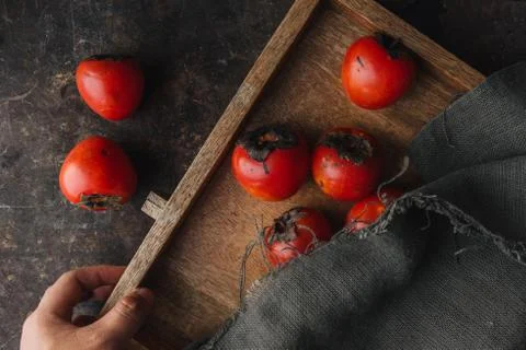 Ripe persimmon on rustic background Stock Photos