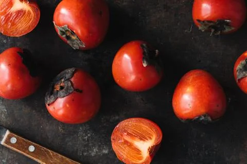 Ripe persimmon on rustic background Stock Photos