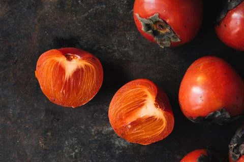 Ripe persimmon on rustic background Stock Photos