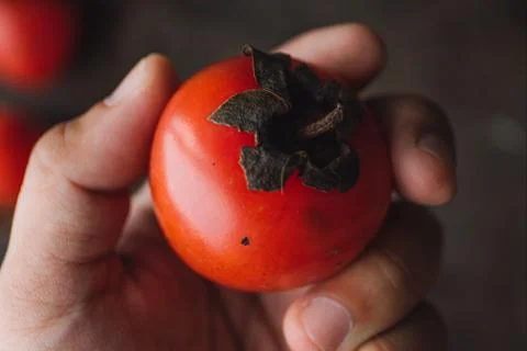Ripe persimmon on rustic background Foto stock