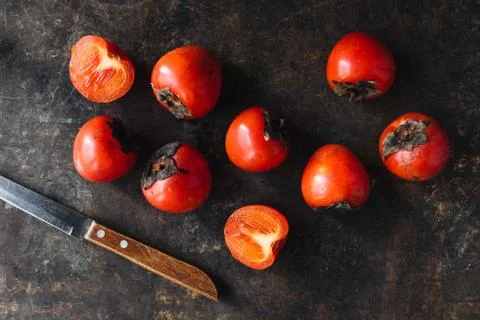Ripe persimmon on rustic background Stock Photos