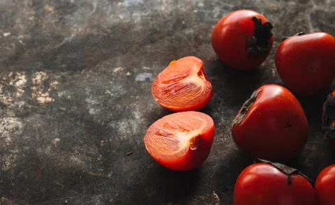 Ripe persimmon on rustic background Stock Photos