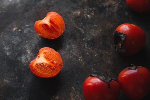 Ripe persimmon on rustic background Stock Photos
