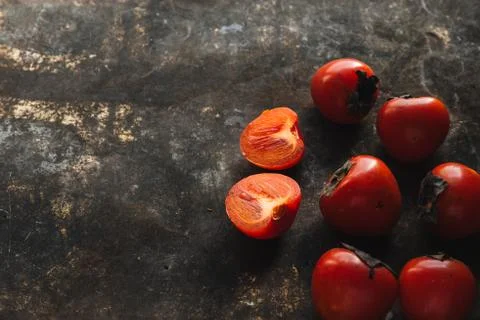 Ripe persimmon on rustic background Stock Photos
