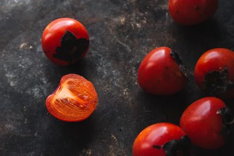 Ripe persimmon on rustic background Stock Photos