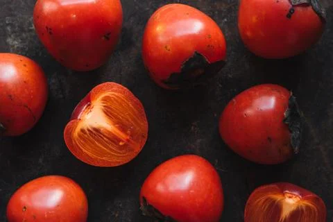 Ripe persimmon on rustic background Stock Photos