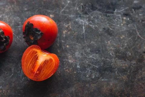 Ripe persimmon on rustic background Foto stock