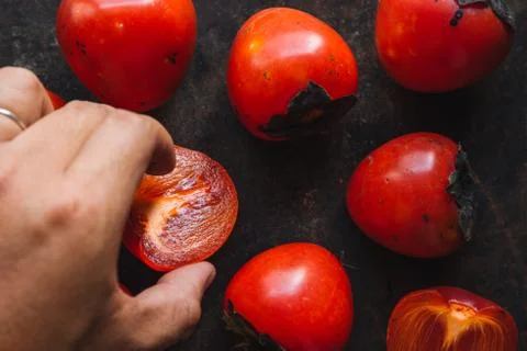Ripe persimmon on rustic background Stock Photos