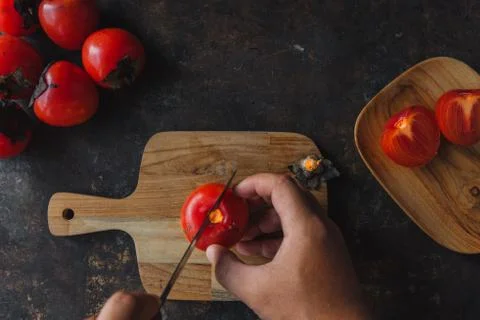 Ripe persimmon on rustic background Foto stock
