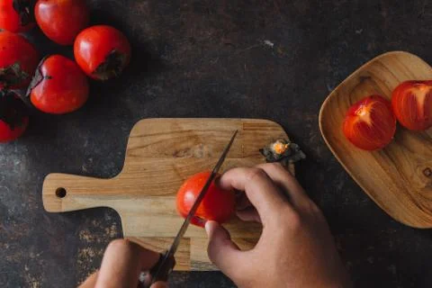 Ripe persimmon on rustic background Stock Photos