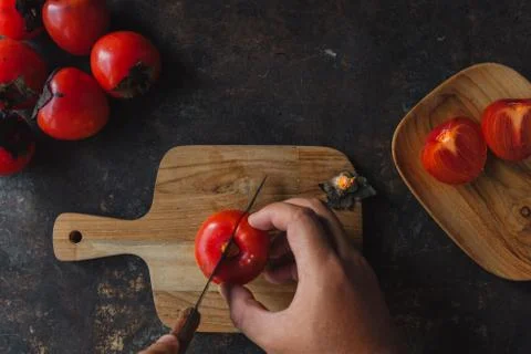 Ripe persimmon on rustic background Stock Photos