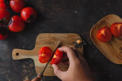 Ripe persimmon on rustic background Stock Photos