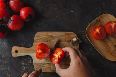 Ripe persimmon on rustic background Stock Photos