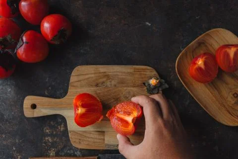 Ripe persimmon on rustic background Stock Photos