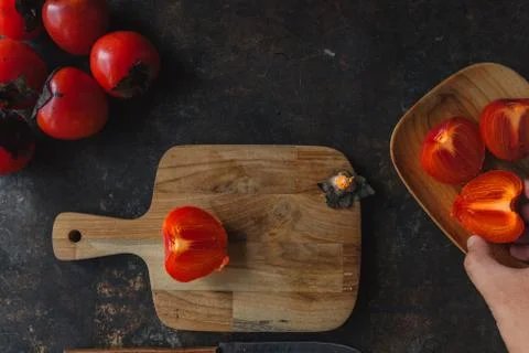 Ripe persimmon on rustic background Stock Photos