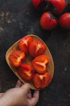 Ripe persimmon on rustic background Stock Photos