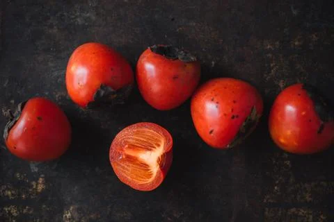 Ripe persimmon on rustic background Foto stock