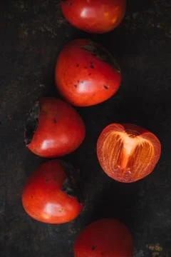 Ripe persimmon on rustic background Stock Photos