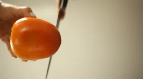 Ripe persimmon slices on a glass table Stock Footage 63087677