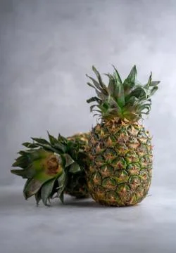 Ripe pineapple on a gray background. Stock Photos