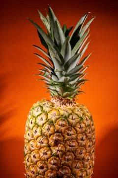 Ripe pineapple on orange background. Close-up shooting Foto stock