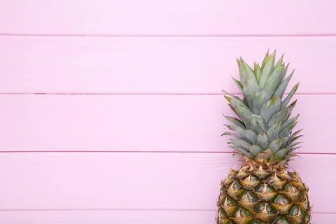 Ripe pineapple on a pink background with copy space Stock Photos