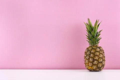 Ripe pineapple on a pink background. Stock Photos