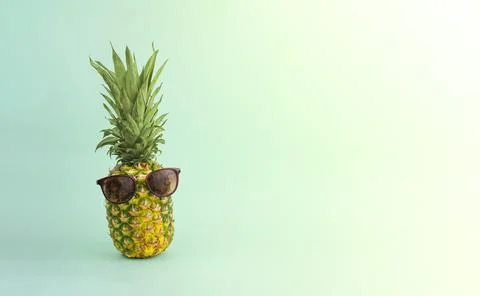 Ripe pineapple in sunglasses on a colored background. Vacation concept. Stock-Fotos