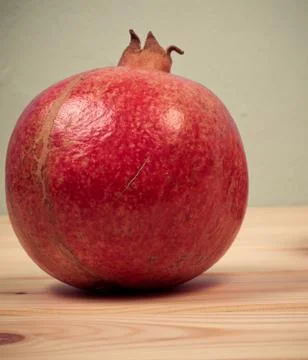 Ripe pomegranate fruit on table wooden Stock-Fotos