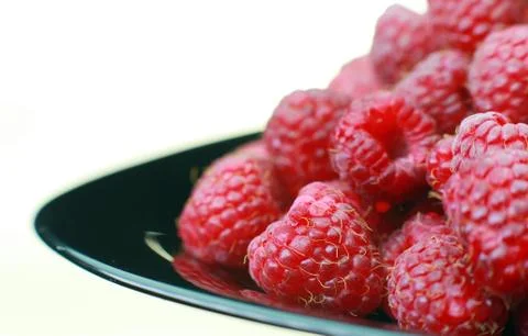 Ripe raspberry close-up. On the plate is a raspberry in the background Foto stock