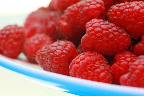 Ripe raspberry close-up. On the plate is a raspberry in the background Stock Photos