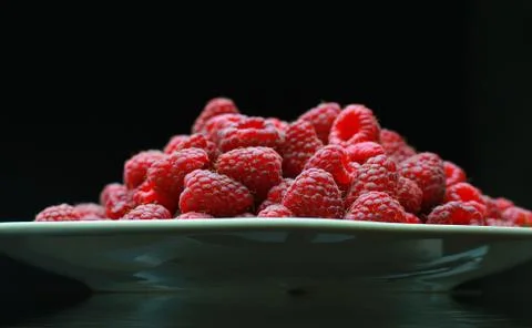 Ripe raspberry close-up. On the plate is a raspberry in the background Foto stock
