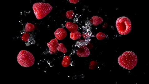 Ripe raspberry with water fly to the camera Video stock 105573538