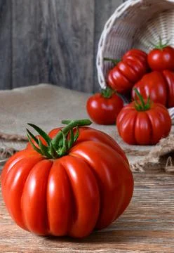 Ripe raw red tomatoes on rustic wooden table Stock Photos