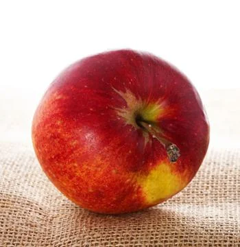 Ripe red apple on burlap Stock Photos