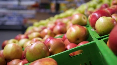 Ripe red apples in green baskets in a store. Ripe fruits. Stock Footage 311966733