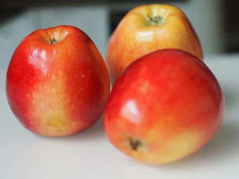 Ripe red apples on the table close-up. Stock Photos