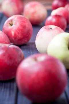 Ripe red apples on a table selective focus vertical photo Stock Photos