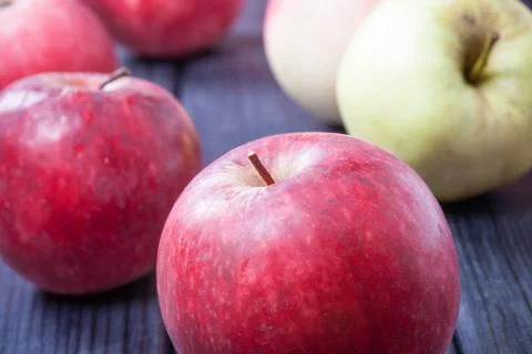 Ripe red apples on a table selective focus photo Stock Photos