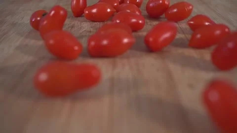 Ripe red cherry tomatoes rolling into plate Stock Footage 131049033