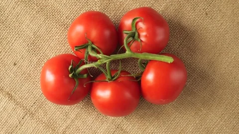 Ripe red cherry tomatoes rotating on a rustic background Stock Footage 337886072