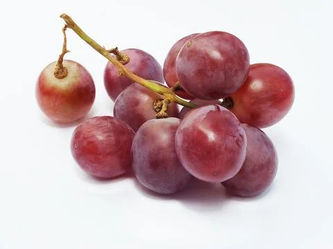 Ripe red grape fruit. bunch of red grape isolated on white. Stock Photos