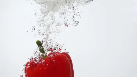 Ripe Red Pepper Falling Through Water. Stock Footage 77973155