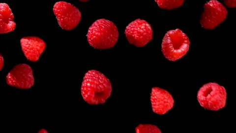 Ripe red raspberries fly and rotates in the air Video stock 104376341